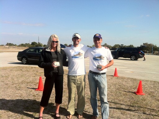 The race director with the winners Dave James and Claire Dorotik after presenting them with their champion buckles.